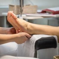 Cropped view of woman getting a pedicure and foot massage